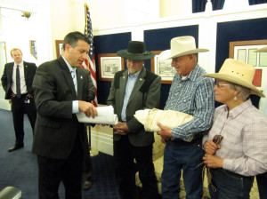 Nevada Gov. Brian Sandoval (from left) accepts petitions from Assemblyman Ira Hansen and Battle Mountain ranchers Peter and Lynn Tomera in May 2014. The Tomeras have received funds from a federal drought disaster relief program. 